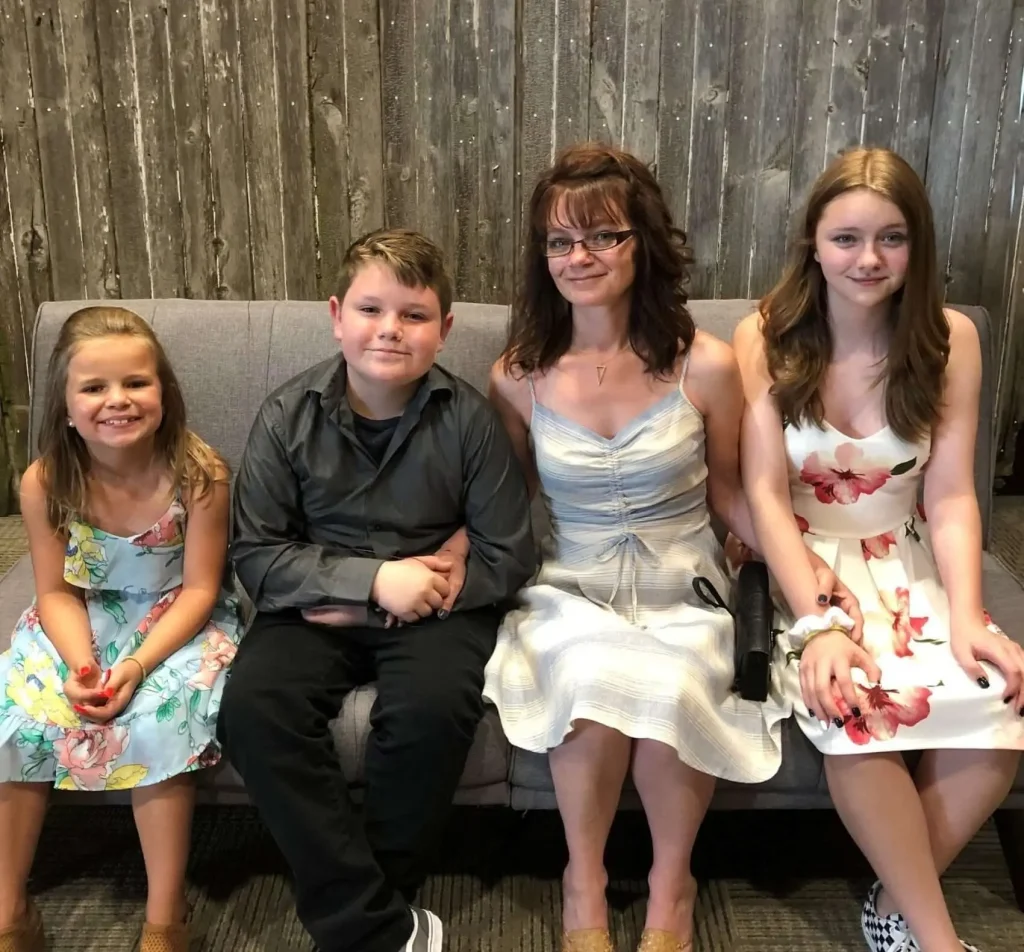 Malissa and her children sitting on a bench.