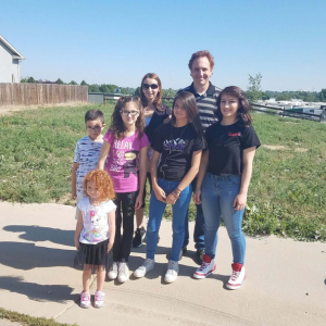 Family photo with 2 adults and 5 children.