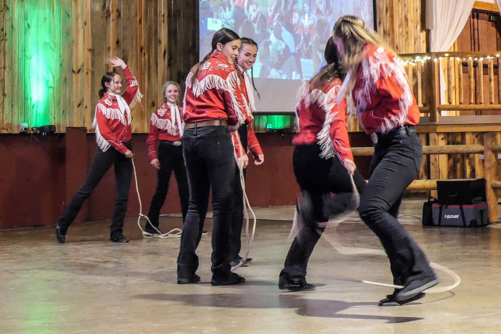 Group of girls line dancing with ropes.