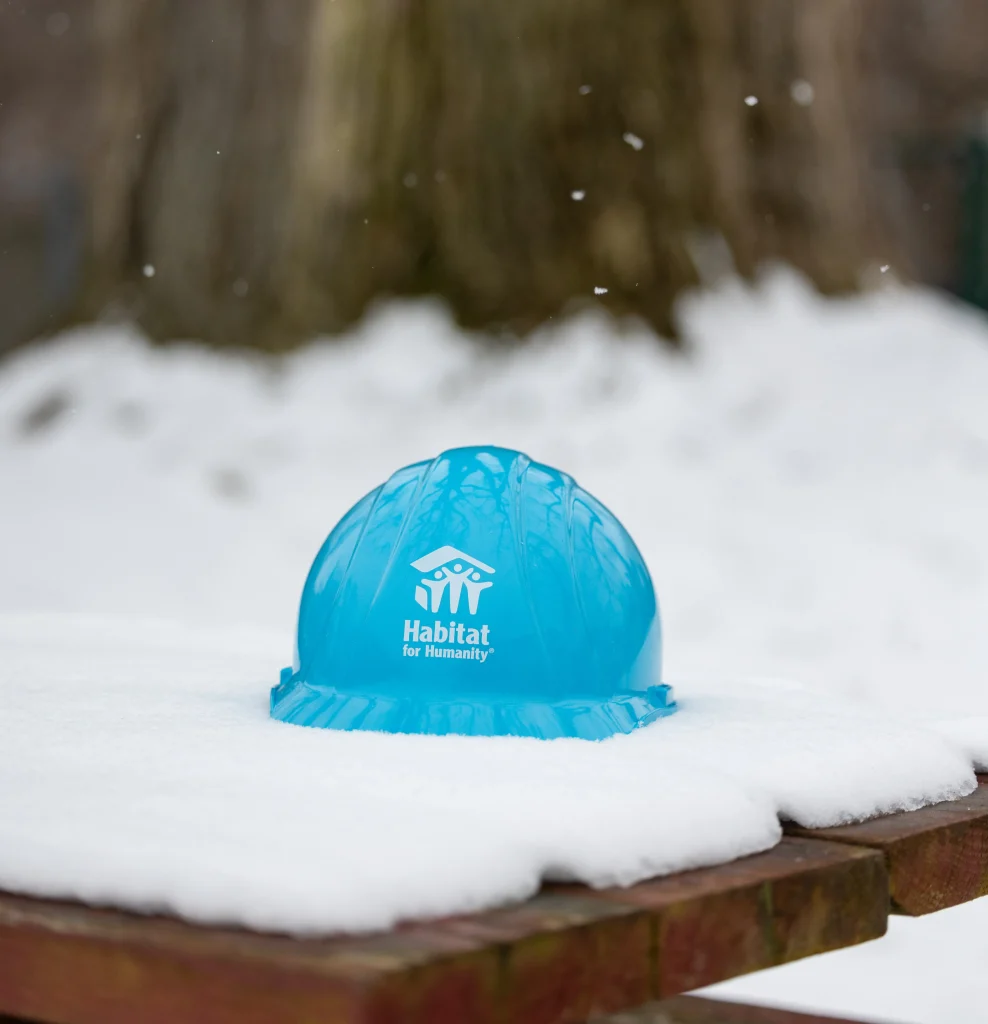 Blue Habitat for Humanity hard hat in snow