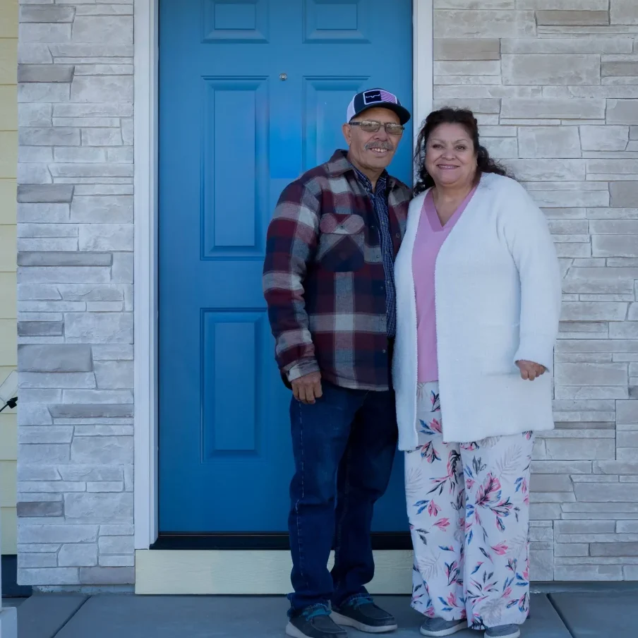 A couple in front of their home. A couple in front of their home.