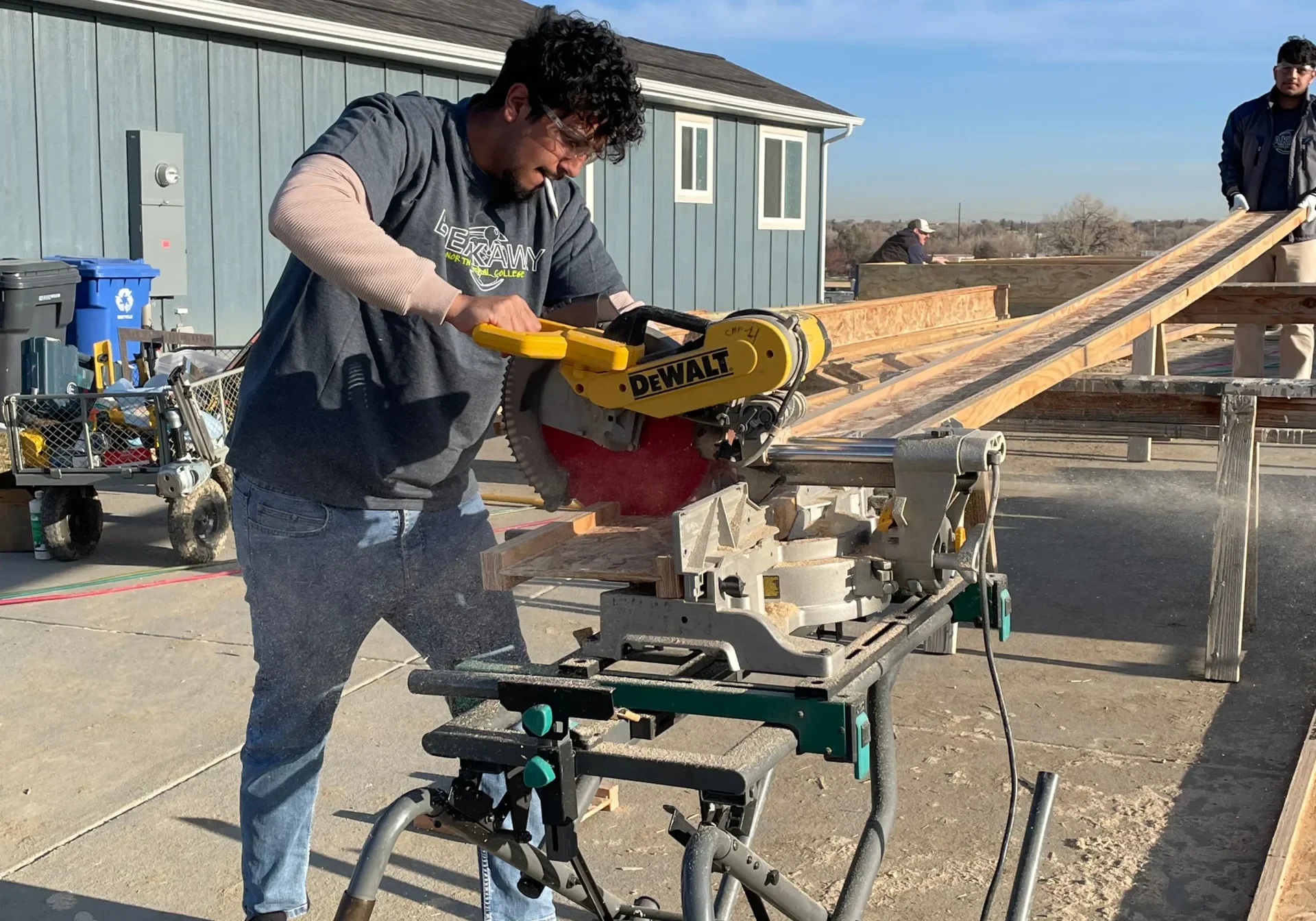 A person using a saw. A person using a saw.